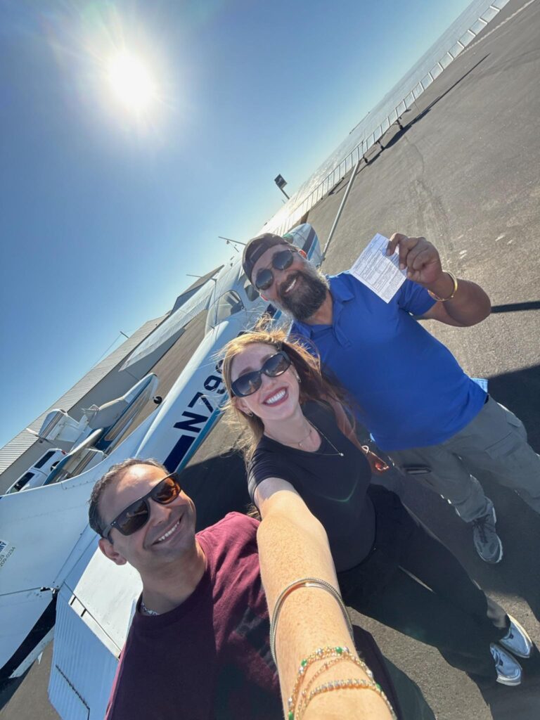 A happy new CFI with her instructors at CFI Academy